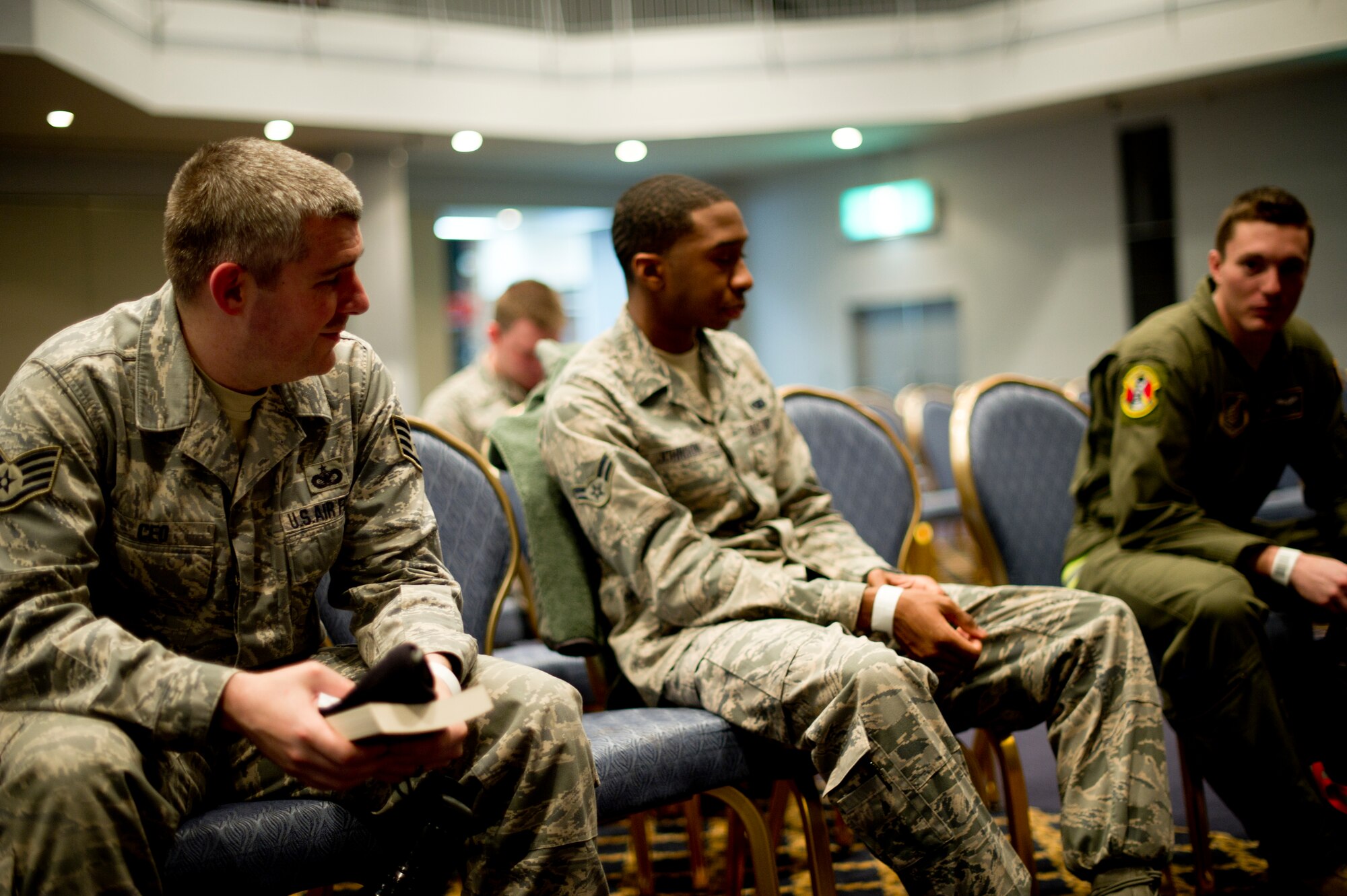 YOKOTA AIR BASE, Japan -- Personnel wait in a holding area after completing their processing during a simulated non-combatant evacuation operation Feb. 22, 2013, at the Taiyo Community Center at Yokota Air Base, Japan.  The NEO was one of many training activities taking place during readiness week at Yokota. (U.S. Air Force photo by Staff Sgt. Stacy Moless)