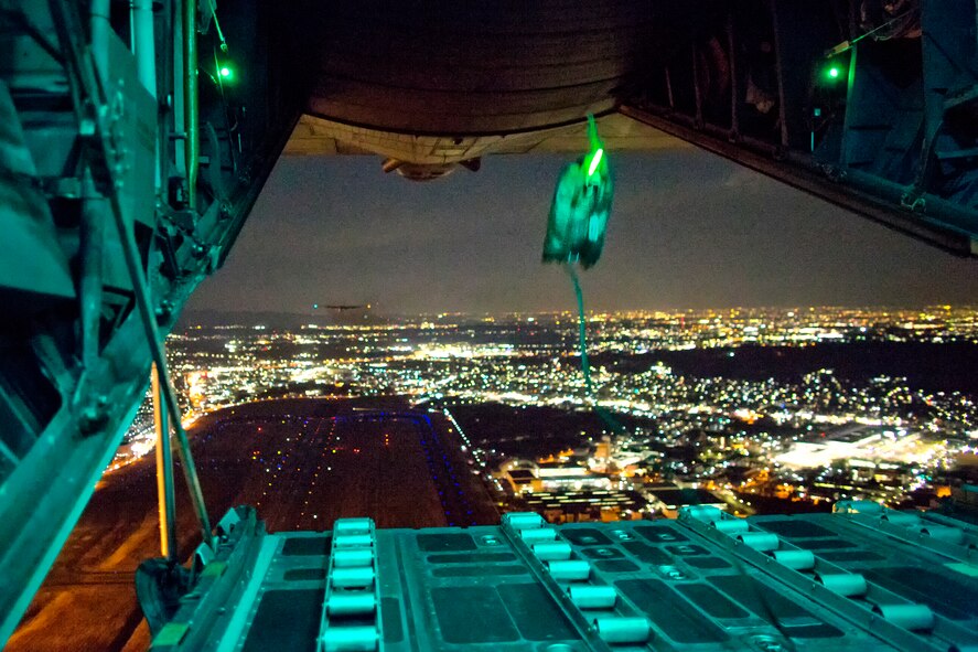 ABOVE YOKOTA AIR BASE, Japan -- A light payload deploys from the rear of a C-130 Hercules during a training mission above Yokota Air Base, Japan, Feb. 21, 2013. The C-130 aircrews demonstrated their airlift capabilities during a readiness week. (U.S. Air Force photo by Osakabe Yasuo)
