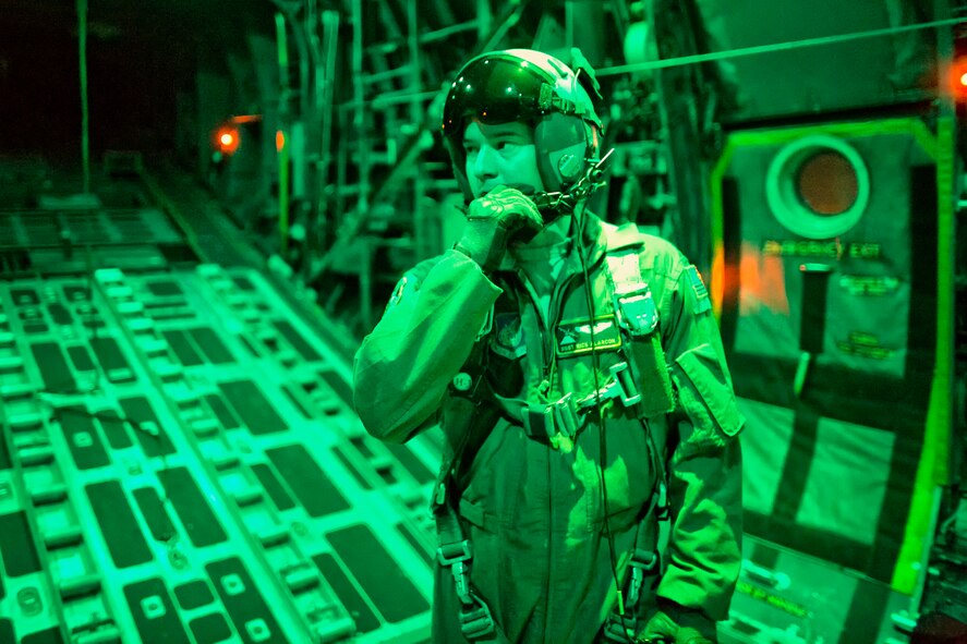 ABOVE YOKOTA AIR BASE, Japan -- Staff Sgt. Nickolas Alarcon, 36th Airlift Squadron loadmaster, communicates with pilots above Yokota Air Base, Japan, Feb. 21, 2013. Yokota conducted a readiness week, allowing Airmen to showcase their professional airlift capabilities and ability to support any contingencies in the Pacific. (U.S. Air Force photo by Osakabe Yasuo)