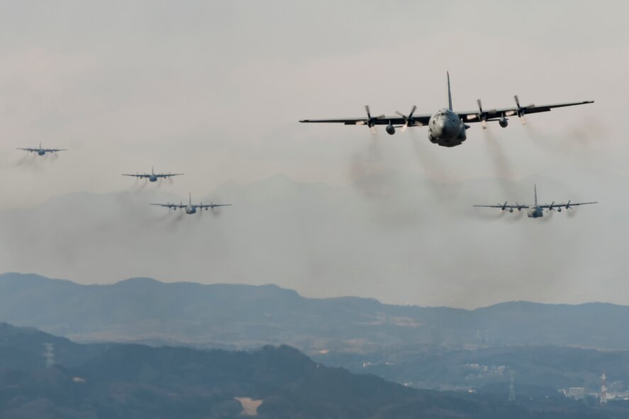 ABOVE YOKOTA AIR BASE, Japan -- Two C-130 Hercules fly a training mission above Yokota Air Base, Japan, Feb. 21, 2013. Six C-130s flew in formation practice different types of air drops in the flight to practice airlift tactics and procedures. (U.S. Air Force Photo by Osakabe Yasuo)