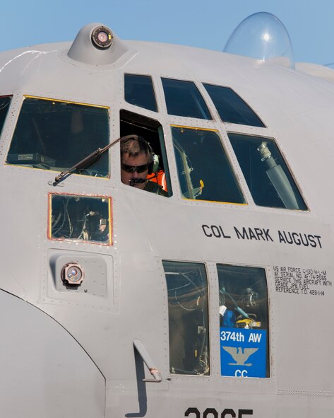 YOKOTA AIR BASE, Japan -- U.S. Air Force Col. Mark August, 374th Airlift Wing commander, performs a pre-flight check on a C-130 Hercules at Yokota Air Base, Japan, Feb. 21, 2013. Six C-130s participated in the flight to practice airlift tactics and procedures. (U.S. Air Force photo by Osakabe Yasuo)