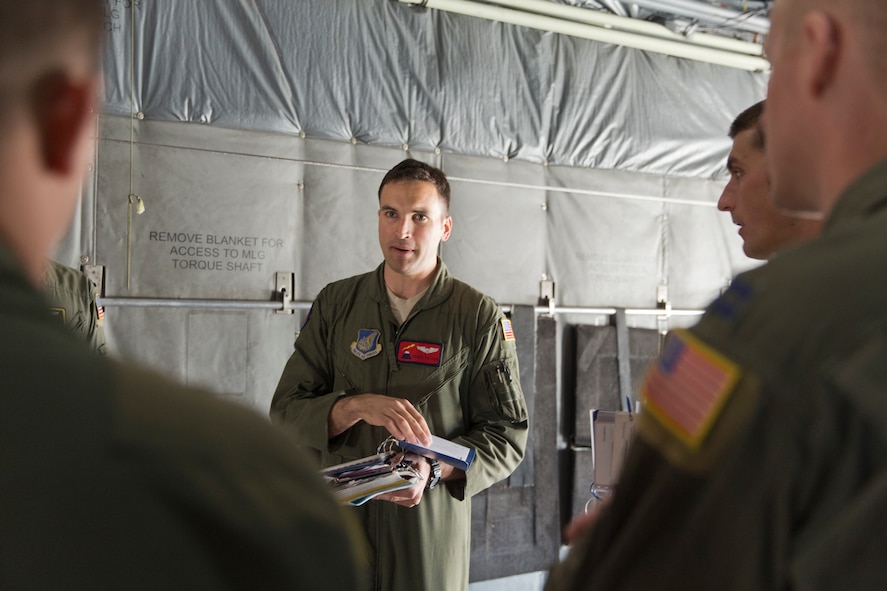 YOKOTA AIR BASE, Japan -- Capt. Travis Patton, 374th Operations Support Squadron, gives a pre-flight briefing to aircrews on a C-130 Hercules at Yokota Air Base, Japan, Feb. 21, 2013. Yokota conducted a readiness week, allowing Airmen to show case their professional airlift capabilities and ability to support any contingencies in the Pacific. (U.S. Air Force photo by Osakabe Yasuo)