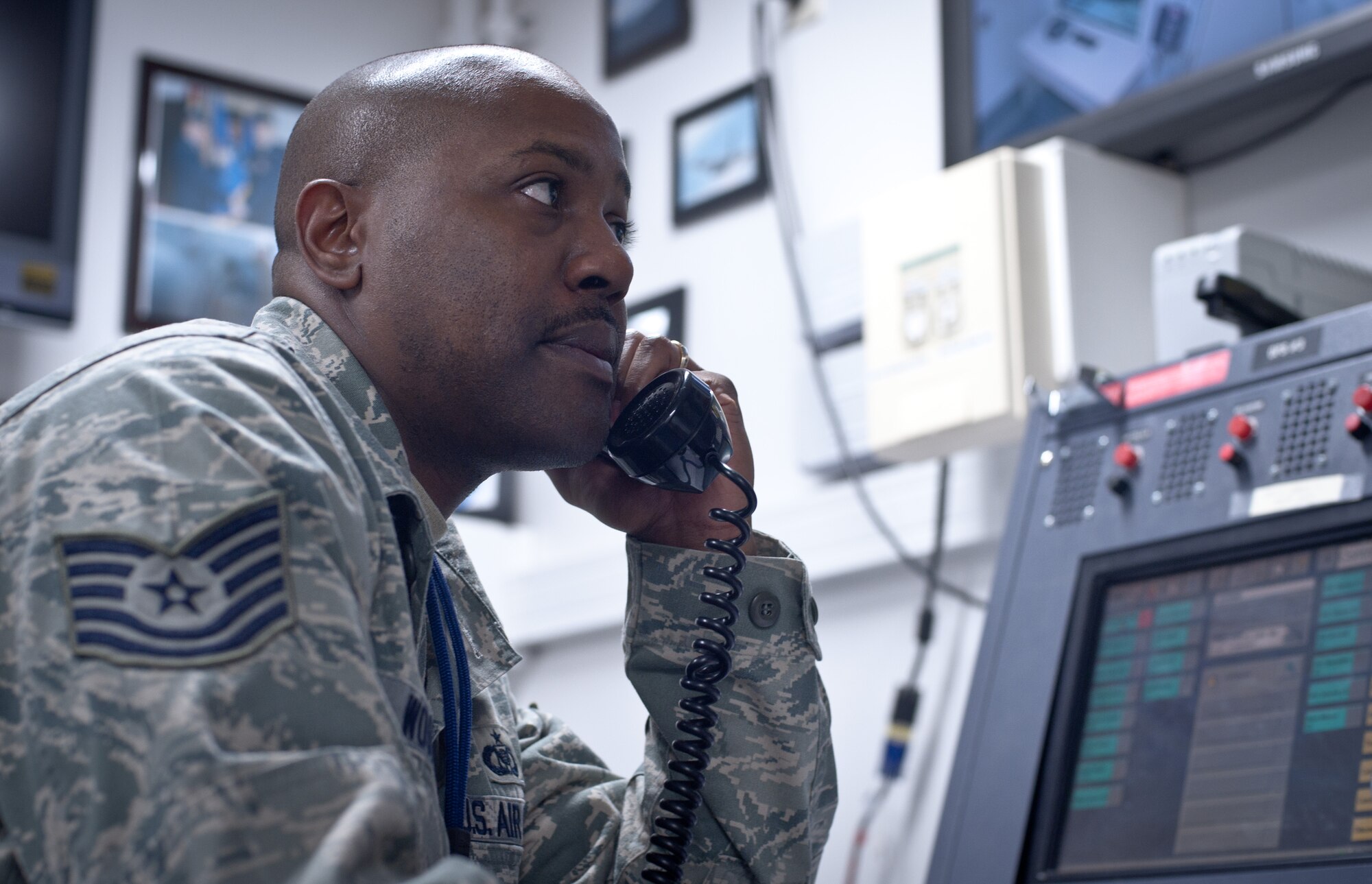 YOKOTA AIR BASE, Japan – Tech. Sgt. Kinnard Woods, 374th Airlift Wing Command Post NCO of console operations, relays information during a wing-wide recall at Yokota Air Base, Japan, Feb. 22, 2013. The recall is one many events planned to test Yokota’s abilities during an ongoing readiness week. (U.S. Air Force photo by 1st Lt. Christopher Love)