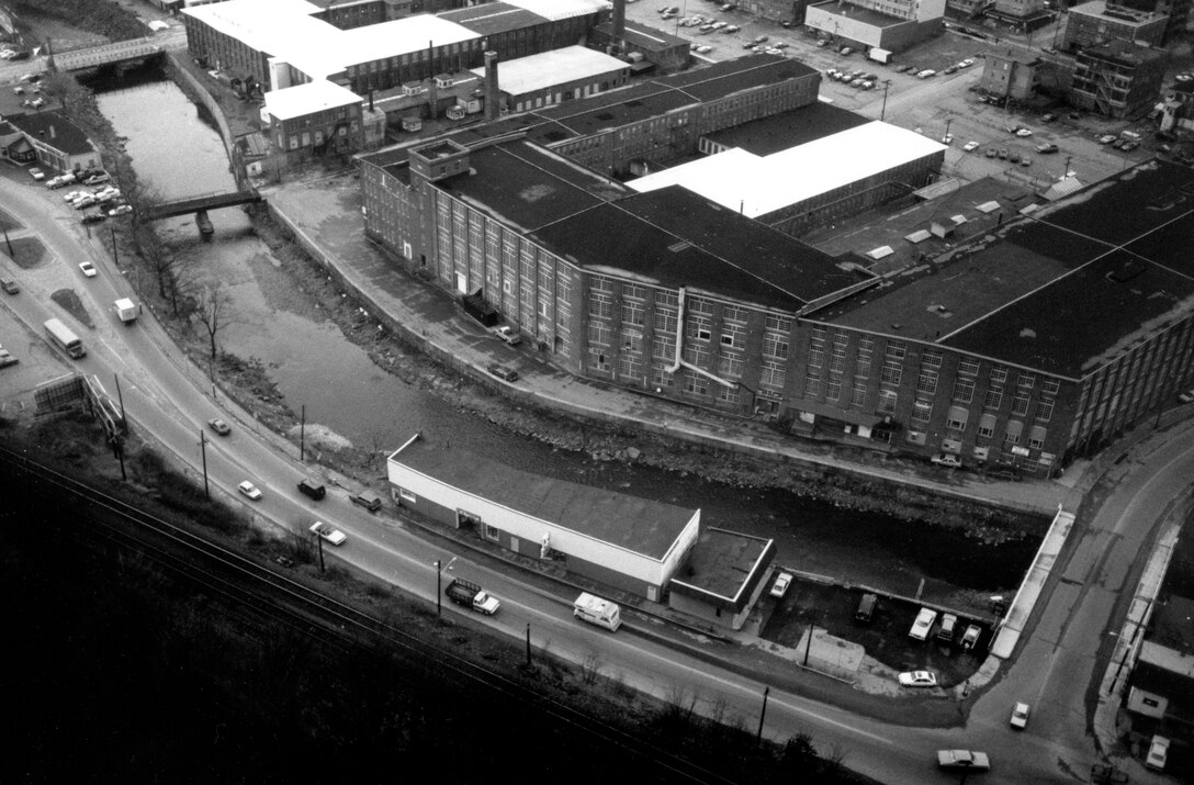 Aerial view of North Nashua River LPP. The North Nashua River Local Protection Project is located on the North Nashua River in Fitchburg. The project safe­guards 50 acres of industrial, commercial, and residential property in Fitchburg. Photo was taken Nov. 1987.