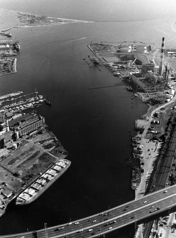 Aerial view of Bridgeport Harbor. Bridgeport Harbor, one of Connecticut's principal commercial ports, lies at the mouth of the Pequonnock River in southeastern Bridgeport, CT. The development of Bridgeport Harbor began in 1836 and has been modified several times. Photograph taken in Oct. 1986.