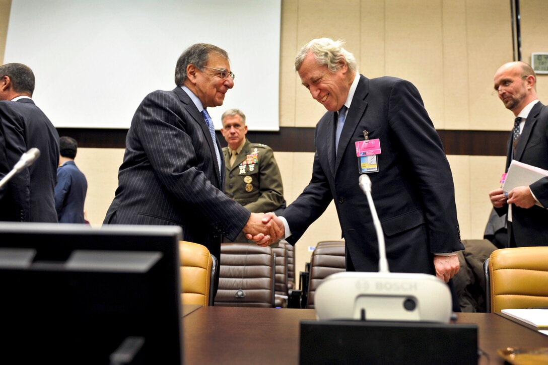 U.S. Defense Secretary Leon E. Panetta, left, greets Pierre Vimont, executive secretary general of the European External Action Service, before a meeting of representatives of the NATO-led International Security Assistance Force at NATO headquarters in Brussels, Feb. 22, 2013. 