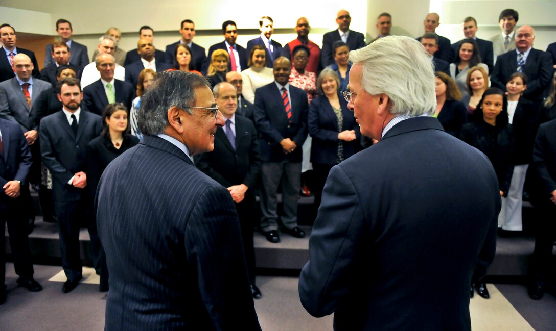 U.S. Ambassador to NATO Ivo Daalder, right, thanks U.S. Defense Secretary Leon E. Panetta as they address a group of U.S. workers assigned to NATO at NATO headquarters in Brussels, Feb. 22, 2013. 