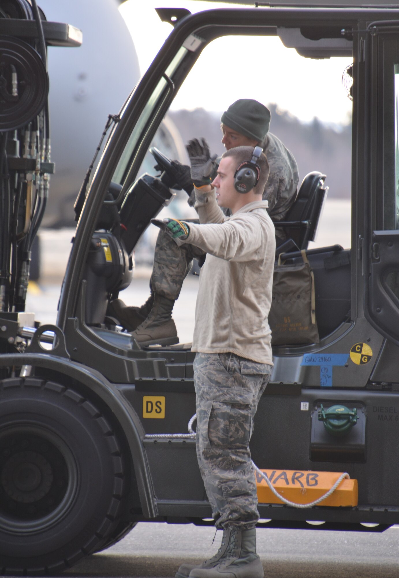 SrA. David Boido assists MSgt. Lori Rysedorph with loading cargo aboard a K-loader Feb. 21. The Airmen, assigned to the 58th Aerial Port Squadron, are part of the Patriot Sands 2013 exercise that began at MacDill Air Force Base, Fla., Feb. 22. (US Air Force photo/MSgt. Andrew Biscoe)