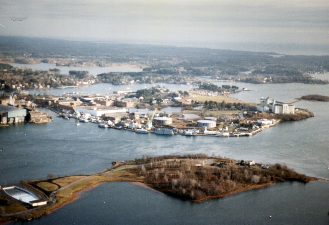 Aerial view of Portsmouth Harbor. Portsmouth Harbor is located on the Piscataqua River, which makes up a portion of the Maine-New Hampshire border. Portsmouth Harbor stretches across the communities of Kittery and Eliot, Maine, and Portsmouth, Newington, and New Castle, New Hampshire.