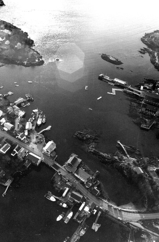 Aerial view of South Bristol Harbor.South Bristol Harbor in South Bristol is located between Bristol Neck and Rutherford Island, along the narrow passage known as "The Gut" that connects the Damariscotta River to the west and Johns Bay to the east. The harbor is 40 miles northeast of Portland and about 14 miles southeast of Bath, ME.  Photo was taken in Dec. 1987.