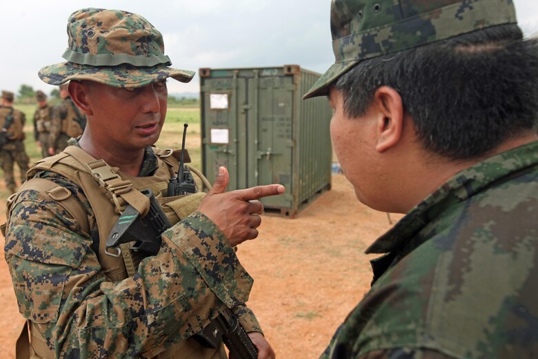 Gunnery Sgt. Marklester M. Ecalnir, a foreign area staff non-commissioned officer for the 31st Marine Expeditionary Unit, coordinates with a Thai Marine officer during the evacuation of Thai citizens for a multinational non-combatant evacuation operation as part of Cobra Gold 2013 here, Feb. 17. Ecalnir specializes in the Southeast-Asia region and brought a deep understanding of each nation's culture to the planning process of the operation and a working knowledge in four of the five languages spoken by the participants. The 31st MEU recently participated in the 32nd iteration of Cobra Gold, a multinational exercise that promotes regional prosperity, security and cooperation among partner militaries. The 31st MEU is the Marine Corps' force in readiness for the Asia-Pacific region and the only continuously forward deployed MEU. 
