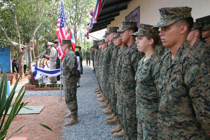 U.S. Marines stand in formation beside their Royal Thai counterparts Feb. 20 during a dedication ceremony for the new building constructed at Ban Kuad Nam Man School, Chat Trakarn District, Phitsanulok province, Kingdom of Thailand, as part of Exercise Cobra Gold 2013. Thai service members are with the 302nd Engineer Battalion, Royal Thai Army. The Marines are with 9th Engineer Support Battalion, 3rd Marine Logistics Group, III Marine Expeditionary Force. Exercise Cobra Gold includes humanitarian and civic assistance projects, a staff exercise and field training exercises. Joint and multinational training is vital to maintaining the readiness and interoperability of all participating military forces.