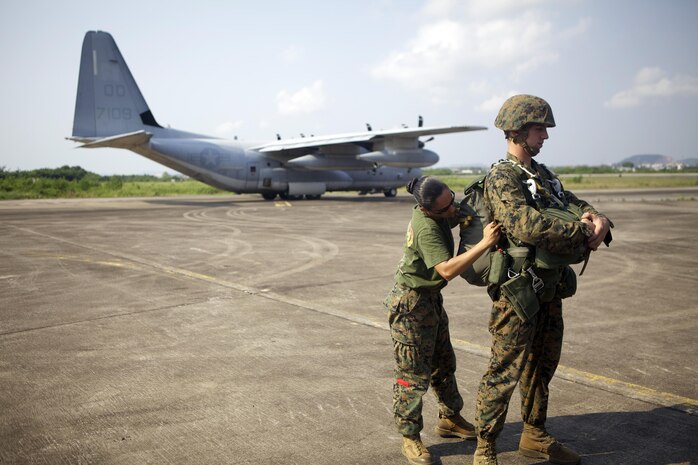 U.S. Marines from Combat Logistics Regiment 3 prepare for a bilateral air delivery jump alongside Royal Thai Marines to foster increased interoperability Feb. 20 during exercise Cobra Gold 2013. CG 13, in its 32nd iteration, is the largest multinational exercise in the Asia-Pacific region and is designed to build interoperability with participating nations and to support peace and stability in the region. CLR-3 is a part of 3rd Marine Logistics Group, III Marine Expeditionary Force.