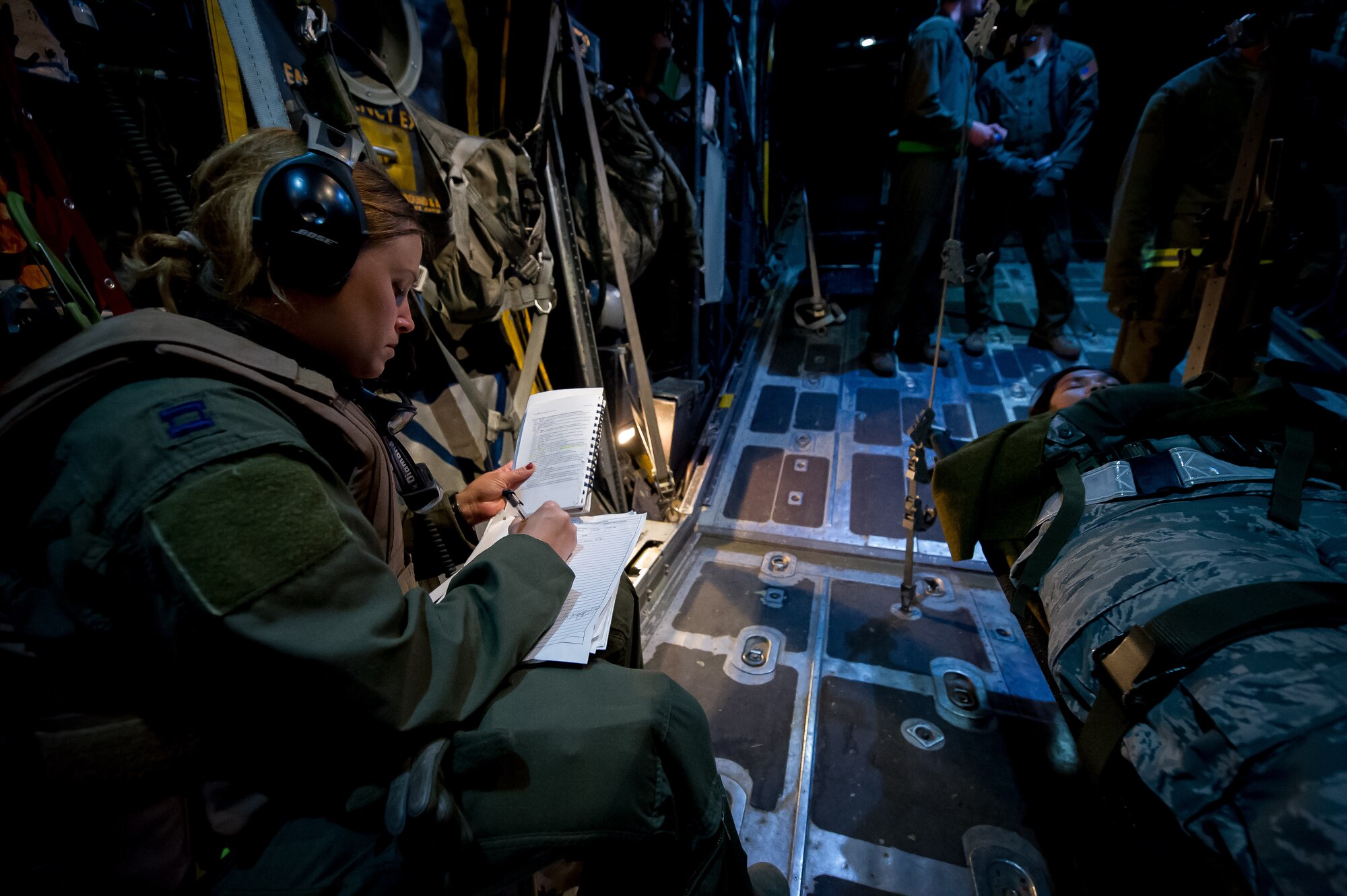 U.S. Air Force Capt. Stefanie Ledford, 18th Aeromedical Evacuation Squadron flight nurse, Kadena Air Base, Japan, records patient vital signs on board a C-130 Hercules aircraft above Alexandria, La., Feb. 22, 2013, in support of Joint Readiness Training Center aeromedical evacuation training. Service members at JRTC 13-04 are educated in combat patient care and aeromedical evacuation in a simulated combat environment. (U.S. Air Force photo by Tech. Sgt. John R. Nimmo Sr.)