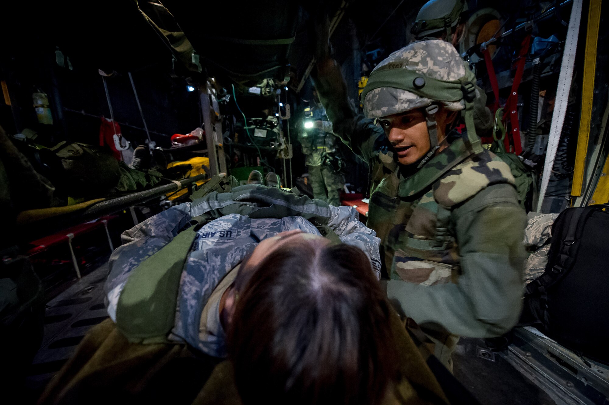 U.S. Air Force Staff Sgt. Kenneth Benavides, 18th Aeromedical Evacuation Squadron, Kadena Air Base, Okinawa, Japan, checks on a simulated patient on board a C-130 Hercules aircraft in Alexandria, La., Feb. 22, 2013, in support of Joint Readiness Training Center aeromedical evacuation training. Service members at JRTC 13-04 are educated in combat patient care and aeromedical evacuation in a simulated combat environment. (U.S. Air Force photo by Tech. Sgt. John R. Nimmo Sr.)