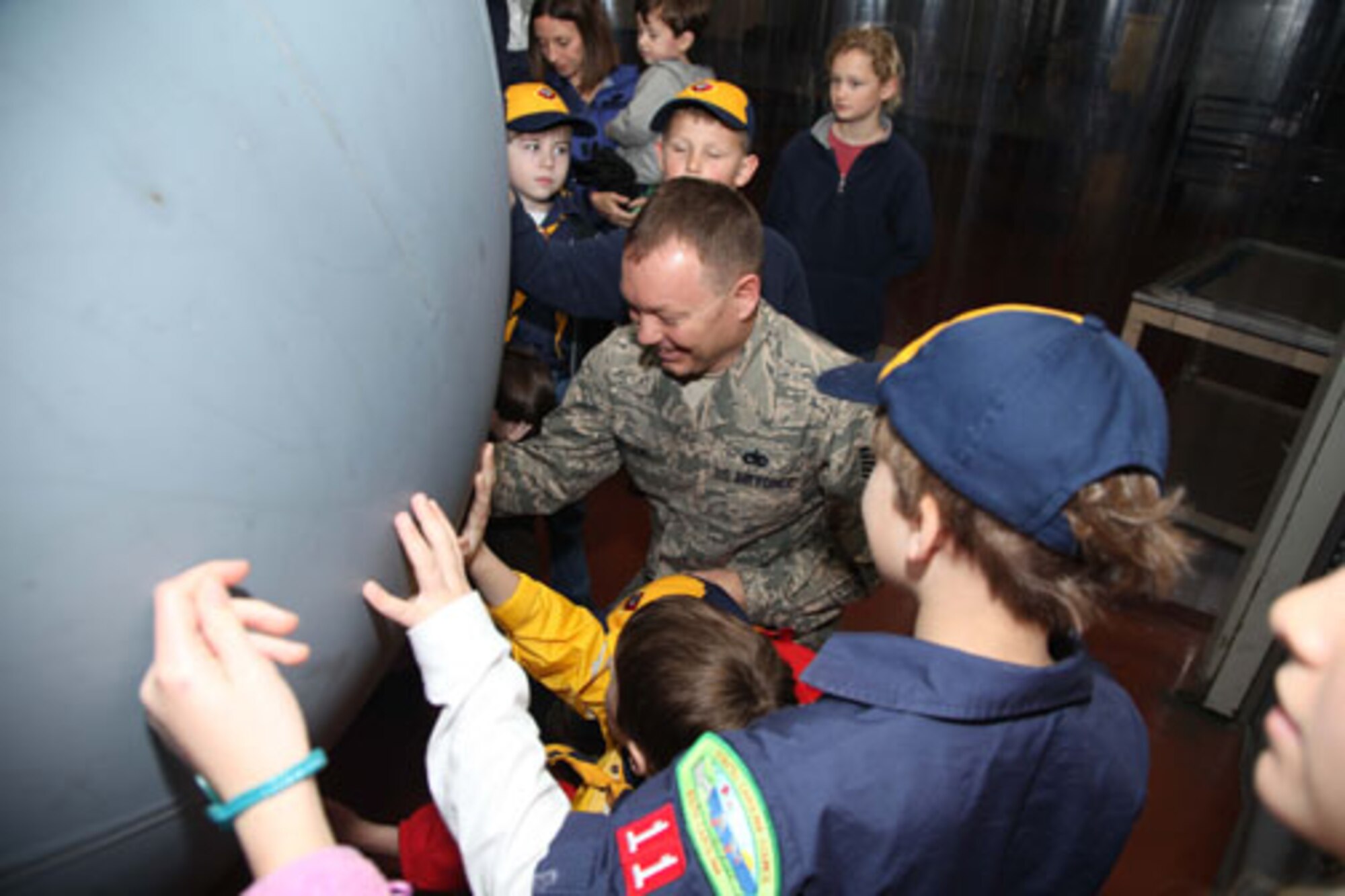 Charleston-based Cub Scouts from Den 5 take a tour of Joint Base Charleston with members of the 315th Airlift Wing Saturday, Feb. 23, 2013.  The Cub Scouts, ranging in age from eight to 11, were met by 315 AW Commander, Col. James J. Fontanella who gave a briefing and video presentation at the start of their tour.  Their visit concluded with a trip to the 315th Maintenance Group's fabrication shop, and followed with the cubs and their parents climbing aboard a C-17 Globemaster III aircraft to see it up close. (U.S. Air Force photo/Staff Sgt. Rashard Coaxum)