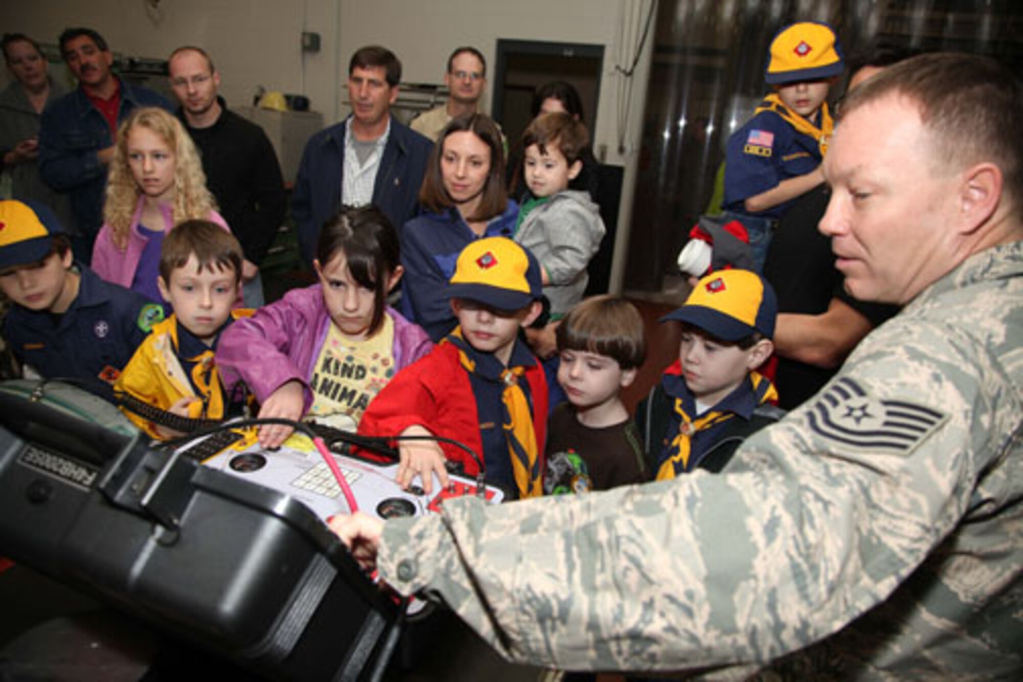 Charleston-based Cub Scouts from Den 5 take a tour of Joint Base Charleston with members of the 315th Airlift Wing Saturday, Feb. 23, 2013.  The Cub Scouts, ranging in age from eight to 11, were met by 315 AW Commander, Col. James J. Fontanella who gave a briefing and video presentation at the start of their tour.  Their visit concluded with a trip to the 315th Maintenance Group's fabrication shop, and followed with the cubs and their parents climbing aboard a C-17 Globemaster III aircraft to see it up close. (U.S. Air Force photo/Staff Sgt. Rashard Coaxum)