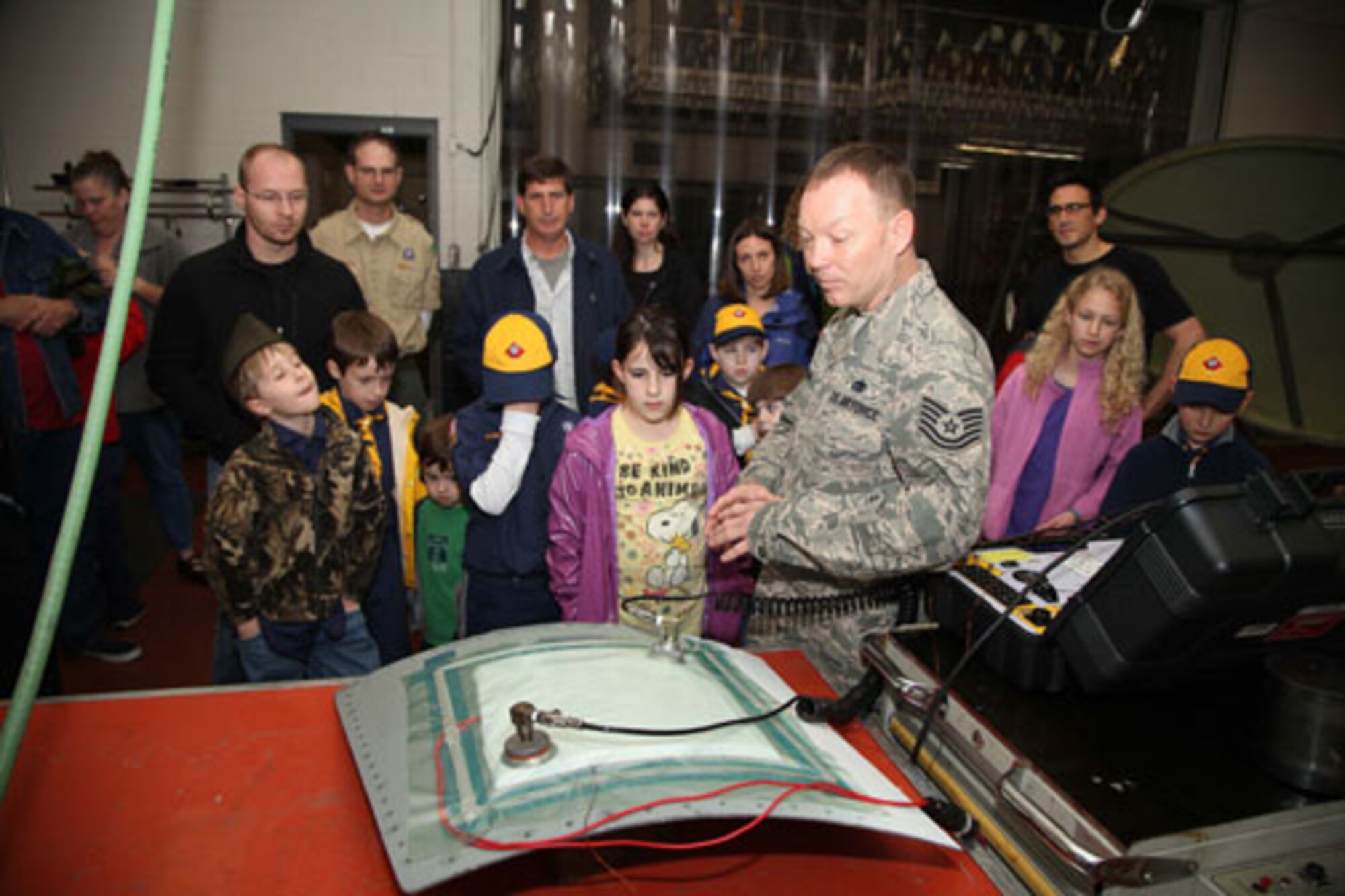 Charleston-based Cub Scouts from Den 5 take a tour of Joint Base Charleston with members of the 315th Airlift Wing Saturday, Feb. 23, 2013.  The Cub Scouts, ranging in age from eight to 11, were met by 315 AW Commander, Col. James J. Fontanella who gave a briefing and video presentation at the start of their tour.  Their visit concluded with a trip to the 315th Maintenance Group's fabrication shop, and followed with the cubs and their parents climbing aboard a C-17 Globemaster III aircraft to see it up close. (U.S. Air Force photo/Staff Sgt. Rashard Coaxum)