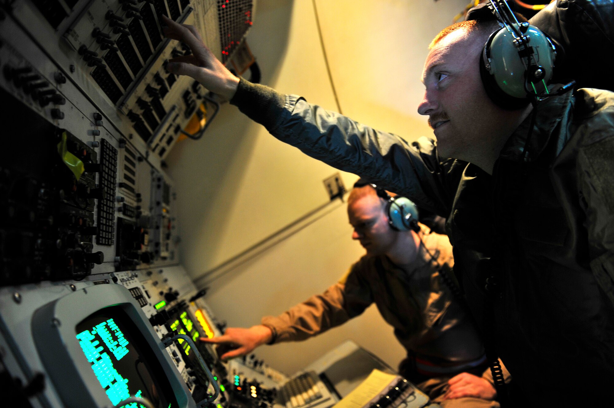 U.S. Air Force Senior Airmen Nathan Schiers and Isaac Harries, 963rd Expeditionary Airborne Air Control Squadron communications systems technicians, accomplish a combat support mission aboard an E-3 Sentry over an undisclosed location in Southwest Asia Feb. 12, 2013. The E-3 Sentry is an airborne warning and control system (AWACS) aircraft that provides all-weather surveillance, command, control and communications needed by U.S. and NATO decision-makers. Schiers and Harries are deployed from the 962nd Airborne Air Control Squadron, Elmendorf Air Force Base, Alaska. (U.S. Air Force photo by Tech. Sgt. Christina M. Styer/Released)