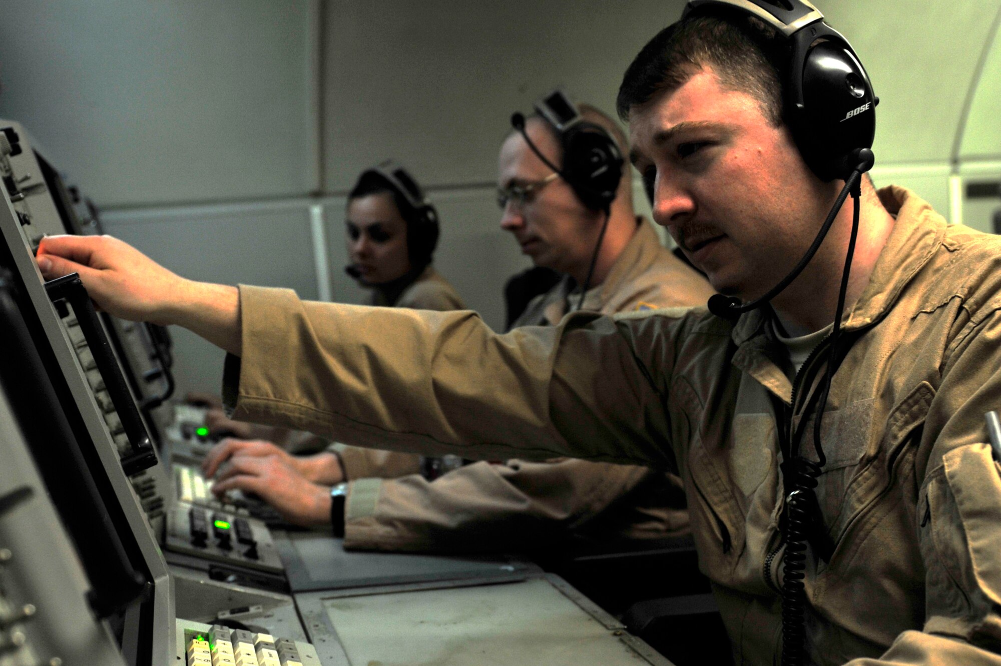U.S. Air Force Airman 1st Class John Custer, Staff Sgt. David Boyd and Senior Airman Autumn Murphy, 963rd Expeditionary Airborne Air Control Squadron airborne surveillance technicians, accomplish a combat support mission aboard an E-3 Sentry over an undisclosed location in Southwest Asia Feb. 12, 2013. The E-3 Sentry is an airborne warning and control system (AWACS) aircraft that provides all-weather surveillance, command, control and communications needed by U.S. and NATO decision-makers. Custer, Boyd and Murphy are deployed from the 962nd Airborne Air Control Squadron, Elmendorf Air Force Base, Alaska. (U.S. Air Force photo by Tech. Sgt. Christina M. Styer/Released) 