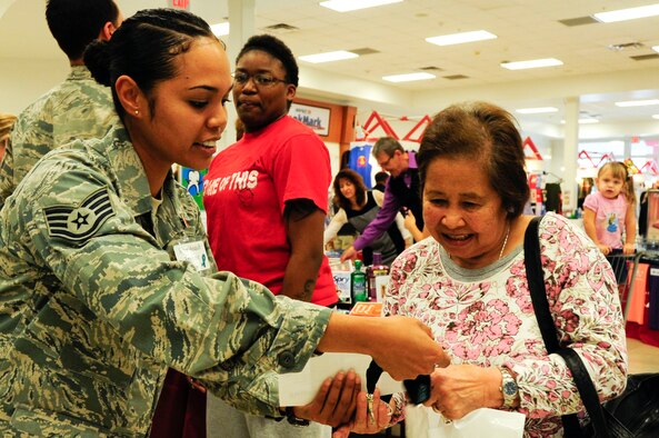 U.S. Air Force Staff Sgt. Vanessa Kyota, 18th Wing NCO in charge of Sexual Assault Prevention Response office, hands information to Linda Apolista during a Joint Services Health Promotion Fair at the Exchange on Kadena Air Base, Japan, Feb. 21, 2013. SARC and victim advocate representatives handed out information and briefed people on the different types of and ways to report sexual assault. This gave the representatives a chance to have a face-to-face interaction with people inside the Exchange. (U.S. Air Force photo/Staff Sgt. Darnell T. Cannady)