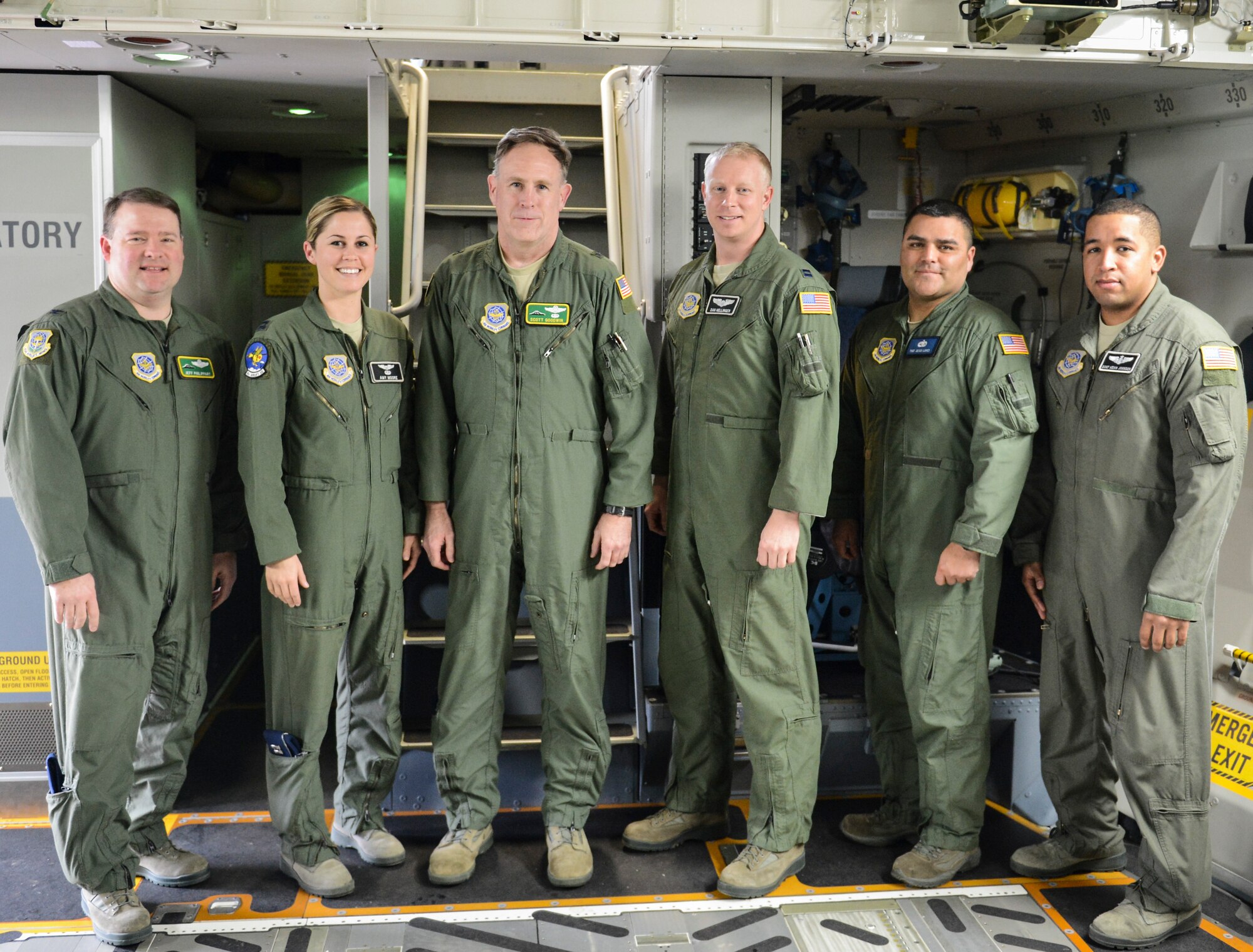 (From left to right) Col. Jeffrey Philippart, 62nd Airlift Wing vice commander, Capt. Amy Moore, 8th Airlift Squadron pilot, Brig. Gen. Scott Goodwin, Air Mobility Command director of operations, Daniel Hellinger, 62nd Operations Support Squadron pilot, Tech. Sgt. Jesus Lopez, 62nd Aircraft Maintenance Squadron flying crew chief, and Staff Sgt. Kevin Johnson, 8th AS loadmaster, stand at the base of the flight deck stairs inside McChord Field's newest C-17 Globemaster III, Feb. 20, 2013, at Joint Base Lewis-McChord, Wash. The crew delivered the aircraft to McChord Field after receiving it from the manufacturer in Long Beach, Calif. (U.S. Air Force photo/Tech Sgt. Sean Tobin) 