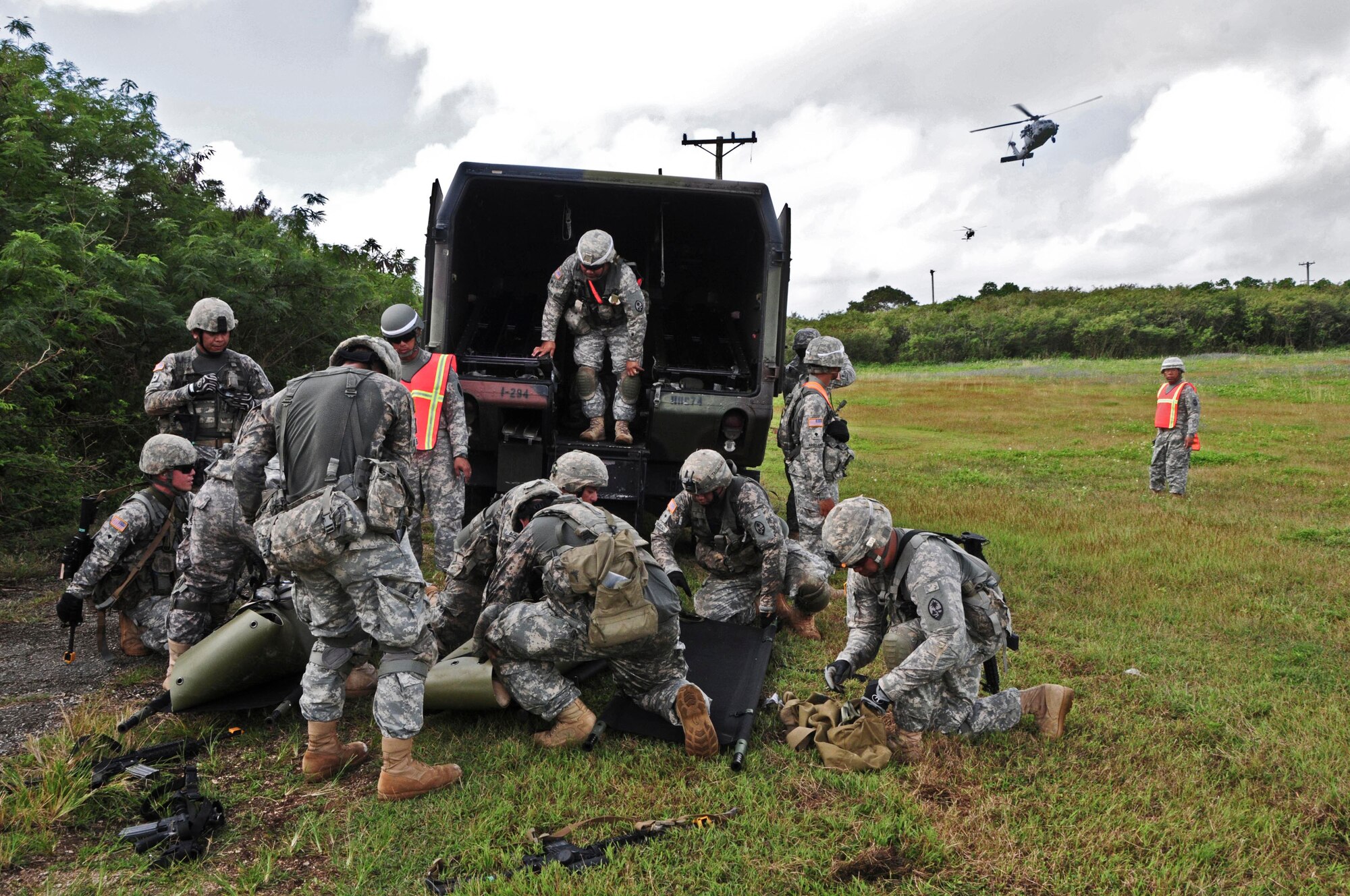 Soldiers from the 1st Battalion, 294th Infantry Regiment, Guam Army National Guard, transfer simulated patients from drag litters to the folding litters in preparation for a medical evacuation at Andersen South, Guam, Feb. 19, 2013. Soldiers were able to make contact with a Helicopter Sea Combat Squadron 25 pilot during the training to request a medical evacuation when the patients were ready for transport.  (U.S. Air Force photo by Airman 1st Class Marianique Santos/Released)