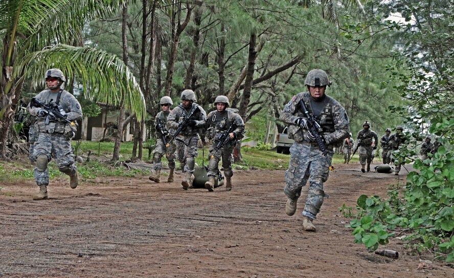 Soldiers from the 1st Battalion, 294th Infantry Regiment, Guam Army National Guard, pull simulated patients on drag litters toward the helicopter landing zone during Combat Life Saver training at Andersen South, Guam, Feb. 19, 2013. Combat Life Saver training is a 40-hour course that teaches Soldiers how to treat injuries under fire. (U.S. Air Force photo by Airman 1st Class Marianique Santos/Released)