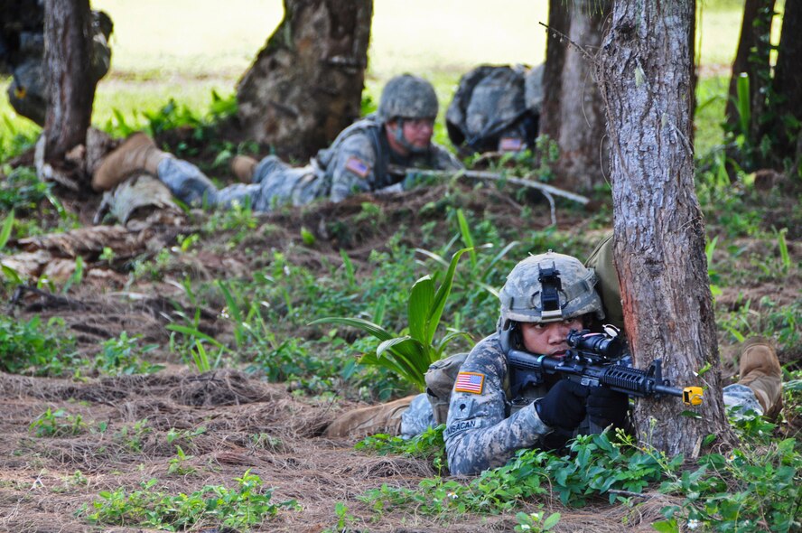 Soldiers from the 1st Battalion, 294th Infantry Regiment, Guam Army National Guard, get in the prone shooting position during a simulated fire fight at Andersen South, Guam, Feb. 19, 2013. Combat Life Saver training is a 40-hour course that teaches Soldiers how to treat injuries under fire. (U.S. Air Force photo by Airman 1st Class Marianique Santos/Released)