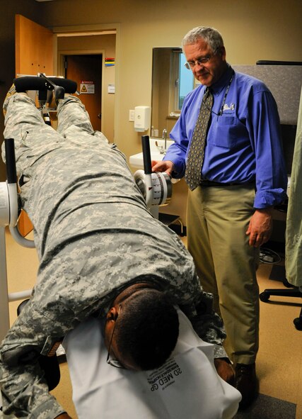 Dr. Philip Hardinger, 2nd Medical Group chiropractor, examines Capt. Dana Capers, U.S. Army Reserves, on Barksdale Air Force Base, La., Feb. 25. The chiropractic section of the 2 MDG provides physical therapy for a variety of injuries such as pinched nerves, bulging disks and pain related to the nervous system. (U.S. Air Force photo/Airman 1st Class Andrew Moua)