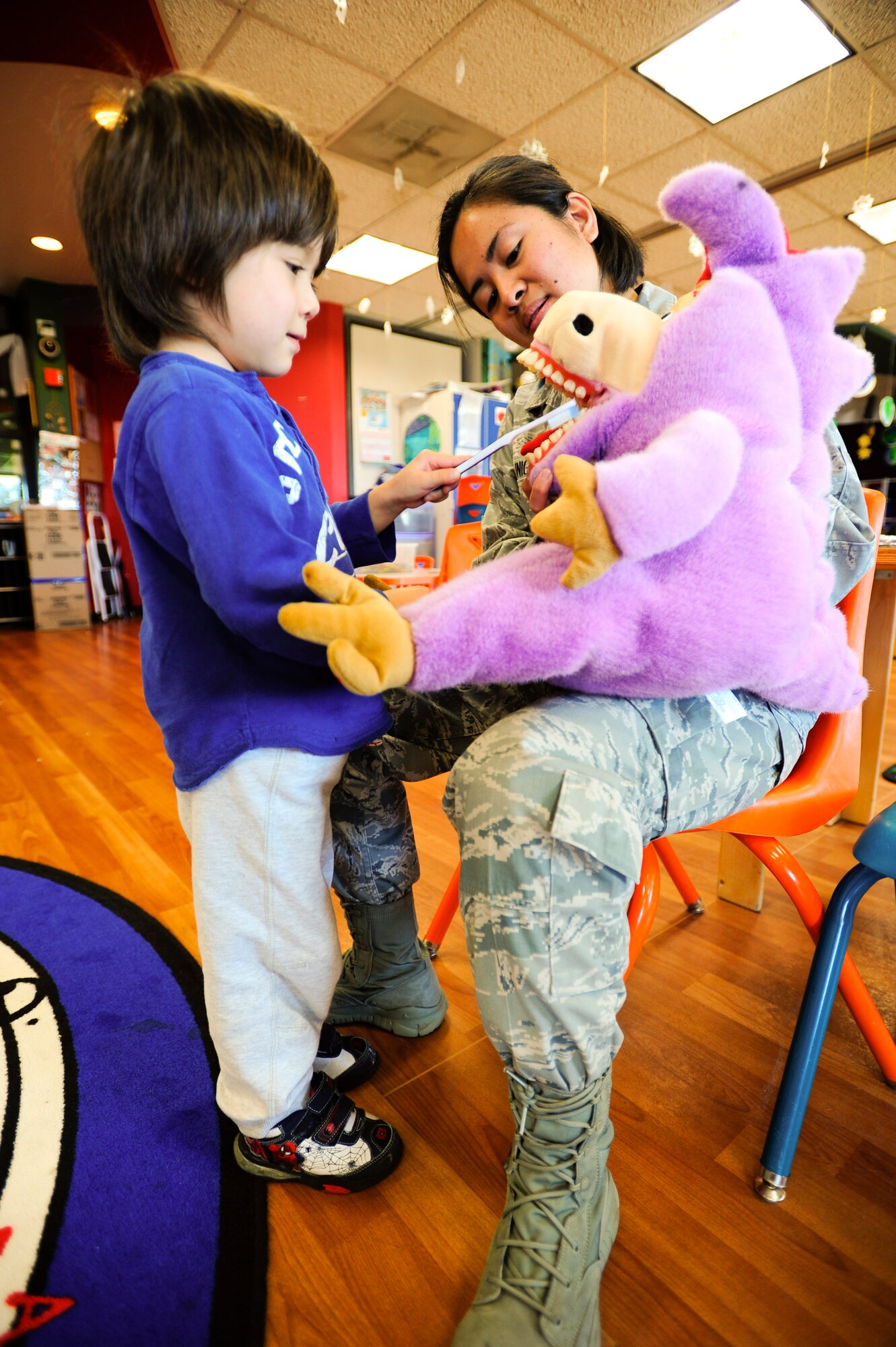 VANDENBERG AIR FORCE BASE, Calif. –Aden Willingham, a Vandenberg Youth Center student, shows Senior Airman Ericka Zuniga, a 30th Medical Operations Squadron dental technician, how to brush his teeth at the Youth Center here Friday, Feb. 22, 2013. In 1981 the Children’s Dental Health Day was extended to a month-long celebration known as National Children’s Dental Health Month. (U.S. Air Force photo/Airman Yvonne Morales)