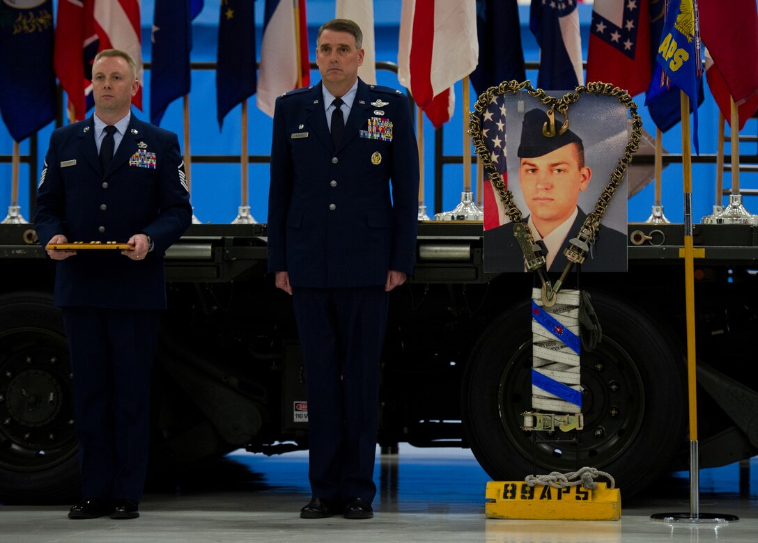 Col. Michael Minihan, 89th Airlift Wing commander, listens as an Air Force Commendation Medal citation for the late Senior Airman John E. King II, 89th Aerial Port Squadron aircraft services specialist, is read during a memorial service held on Joint Base Andrews, Md., Feb. 22, 2013. King passed away while on duty Feb. 17, leaving behind his wife, Airman 1st Class Natalee King, and his son, John James King III. (U.S. Air Force photo/Staff Sgt. Perry Aston)