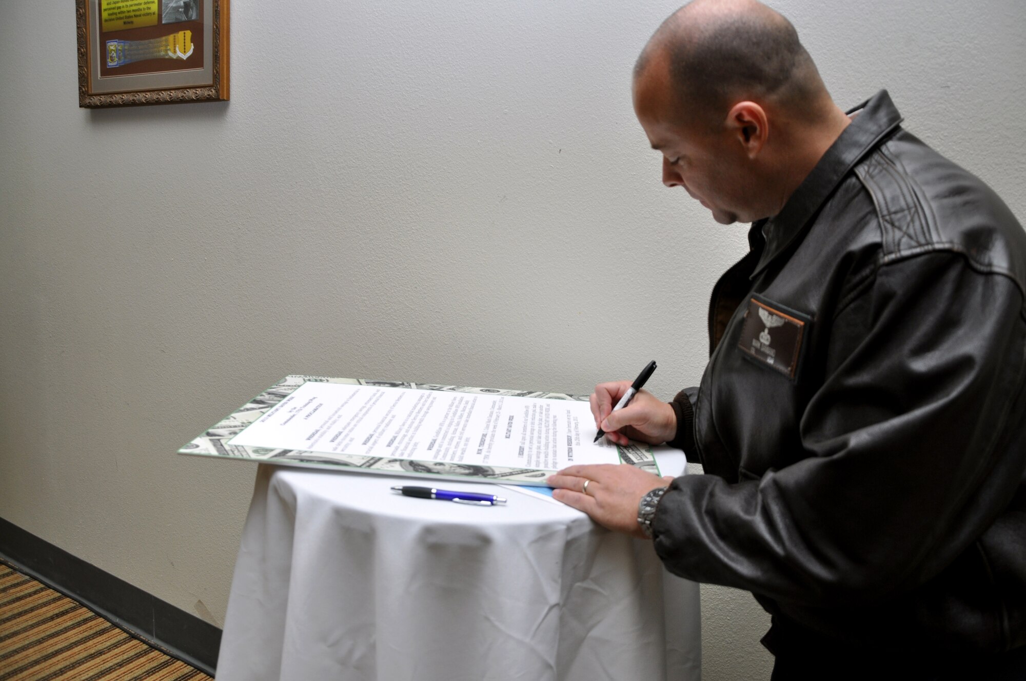 GOODFELLOW AIR FORCE BASE, Texas—Col. Mark Damiano, 17th Training Wing Commander, signs a proclamation signifying the start of the annual Military Saves Campaign for Team Goodfellow, Feb. 25, at the Event Center. The event marks a time for military members and their families to focus on their finances and prepare for the future. (U.S. Air Force photo/Airman Jessica Keith) 
