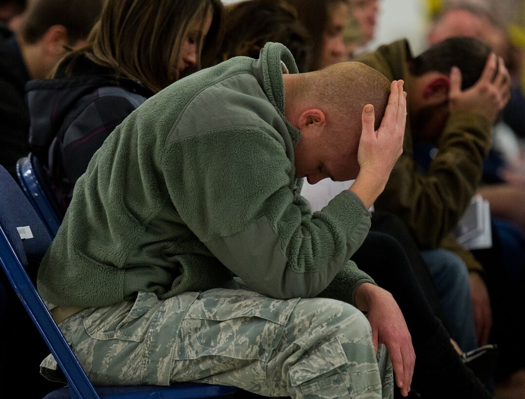 Friends mourn during a memorial ceremony held for the late Senior Airman John E King II, 89th Aerial Port Squadron aircraft services specialist at Joint Base Andrews, Md., Feb. 22, 2013. King passed away while on duty Feb. 17. As an aircraft services specialists, King provided airlift ground support for the president, vice president, cabinet secretaries, key congressional members, and other dignitaries worldwide. (U.S. Air Force photo/Staff Sgt. Perry Aston)