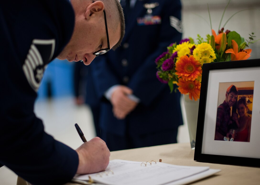 Airmen sign the guest book for the late Senior Airman John E King II, 89Aerial Port Squadron aircraft services specialist during a memorial ceremony held in his honor Feb. 22, 2013, on Joint Base Andrews, Md. King passed away while on duty Feb. 17. (U.S. Air Force photo/Staff Sgt. Perry Aston)
(Released)