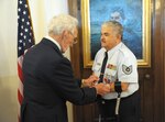Retired Air Force Tech. Sgt. Palacio Salazar receives the Purple Heart from retired Air Force Col. Colin Chauret Feb.15 at the Joint Base San Antonio-Randolph Taj Mahal.  Salazar was wounded in action as an Airman First Class while stationed at Bien Hoa Air Base, Vietnam, Aug. 21, 1965.
(U.S. Air Force photo by Joel Martinez)