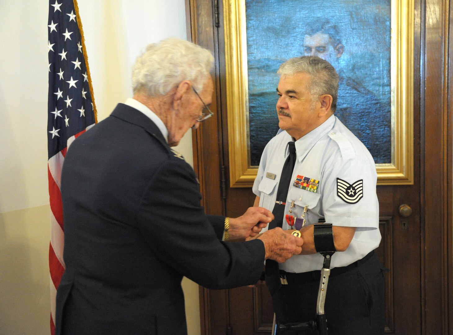 Retired Air Force Tech. Sgt. Palacio Salazar receives the Purple Heart from retired Air Force Col. Colin Chauret Feb.15 at the Joint Base San Antonio-Randolph Taj Mahal.  Salazar was wounded in action as an Airman First Class while stationed at Bien Hoa Air Base, Vietnam, Aug. 21, 1965.
(U.S. Air Force photo by Joel Martinez)