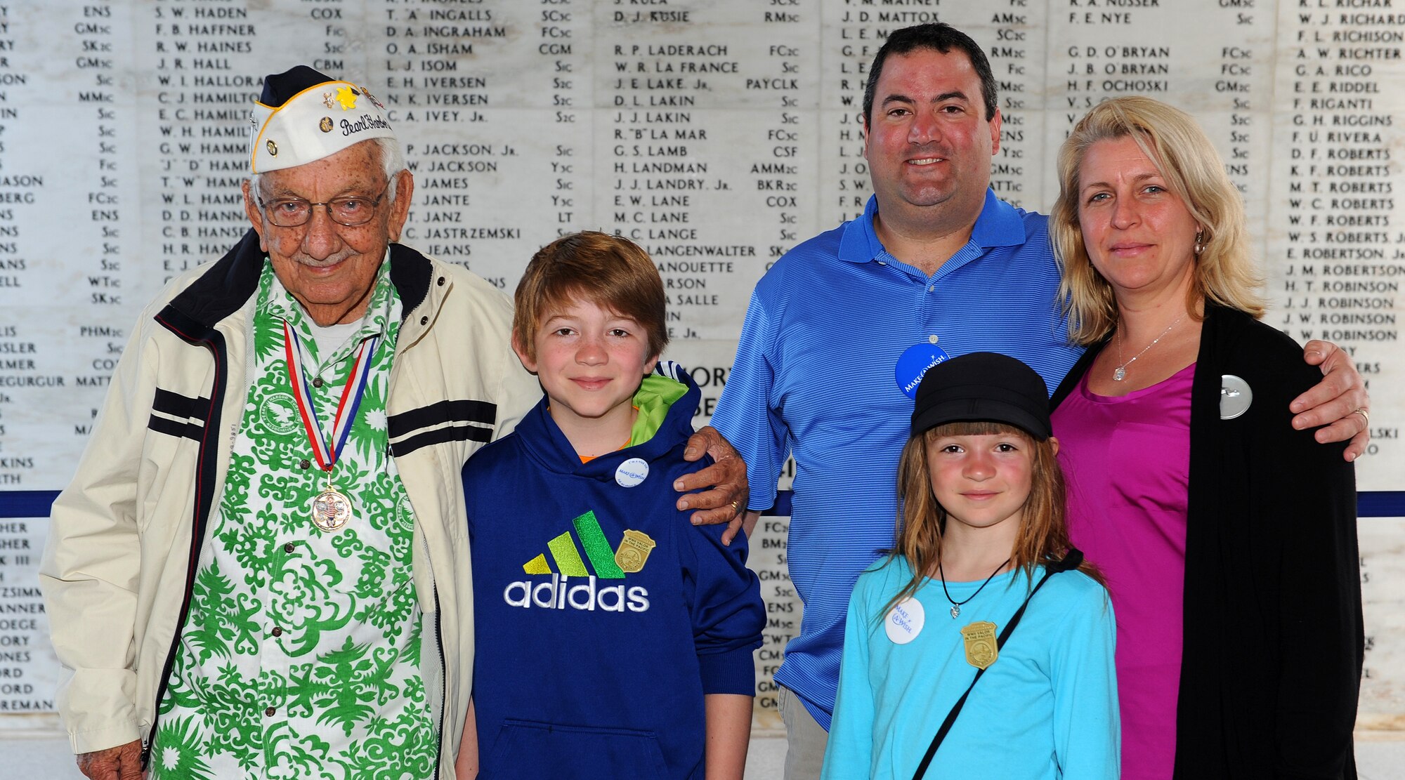 Pearl Harbor attacks survivor, Alfred Benjamin Kame’eiamoku Rodrigues, US Navy (retired) poses for a group photo with Carl Hess, Make-A-Wish recipient, Carl’s sister Kayelynn Hess and his parents James and Heidi Sullivan, at the USS Arizona Memorial near Ford Island, Hawaii, Feb. 19, 2013. Carl is fighting acute lymphoblastic leukemia (ALL), a fast-growing cancer of the white blood cells, and wished to be a downed World War II pilot.  During his visit he received a rare opportunity to spend the night aboard the USS Missouri, fly in a bi-plane, and tour various historical WWII sites. (U.S. Air Force photo/Tech. Sgt. Jerome S. Tayborn)
