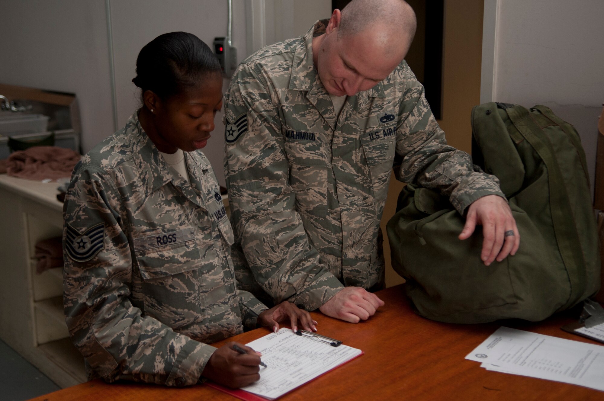 U.S. Air Force Tech. Sgt. Wonda Ross, 23d Logistic Readiness Squadron individual protective equipment, shows Staff Sgt. Yasser Mahmound a list of the gear he will receive at Moody Air Force Base, Ga., Feb. 10, 2013. The 23d LRS IPE flight has been issuing exercise gear for the past month to equip Moody for the upcoming operational readiness exercise. (U.S. Air Force Photo by Airman Paul Francis/Released)
