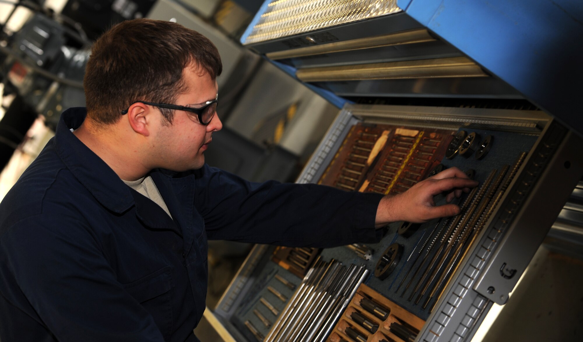 U.S. Air Force Staff Sgt. Raymond Russell, 1st Maintenance Squadron Metals Technology aircraft metals technologist, selects the proper size tool for a piece of equipment at Langley Air Force Base, Va., Feb. 19, 2013. Metals technologists at Langley have also worked on air conditioning units, tire cages and even supplies for hospital construction. (U.S. Air Force photo by Senior Airman Teresa Aber/Released)