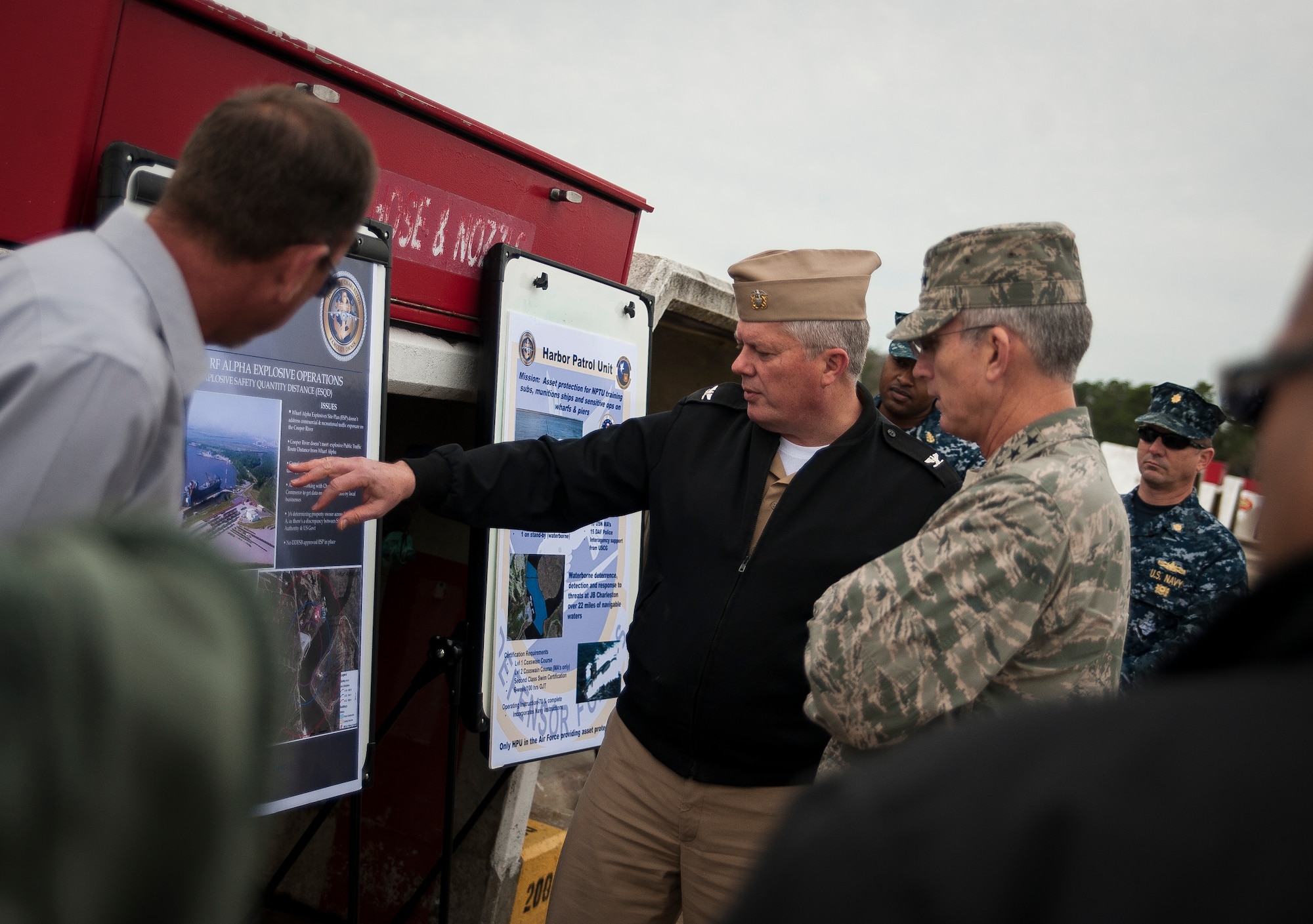 Navy Capt. Tom Bailey, Joint Base Charleston deputy commander, discusses ammo loading operations with Gen. Paul Selva, Air Mobility Command commander Feb. 13, 2013, at JB Charleston – Weapons Station, S.C. The visit enabled the general to witness the Total Force Concept of JB Charleston in action. He met with active duty and Reserve Airmen on the flight line, as well as service members from every branch of the armed forces at various units throughout the Air Base and Weapons Station. (U.S. Air Force photo/Senior Airman Dennis Sloan)