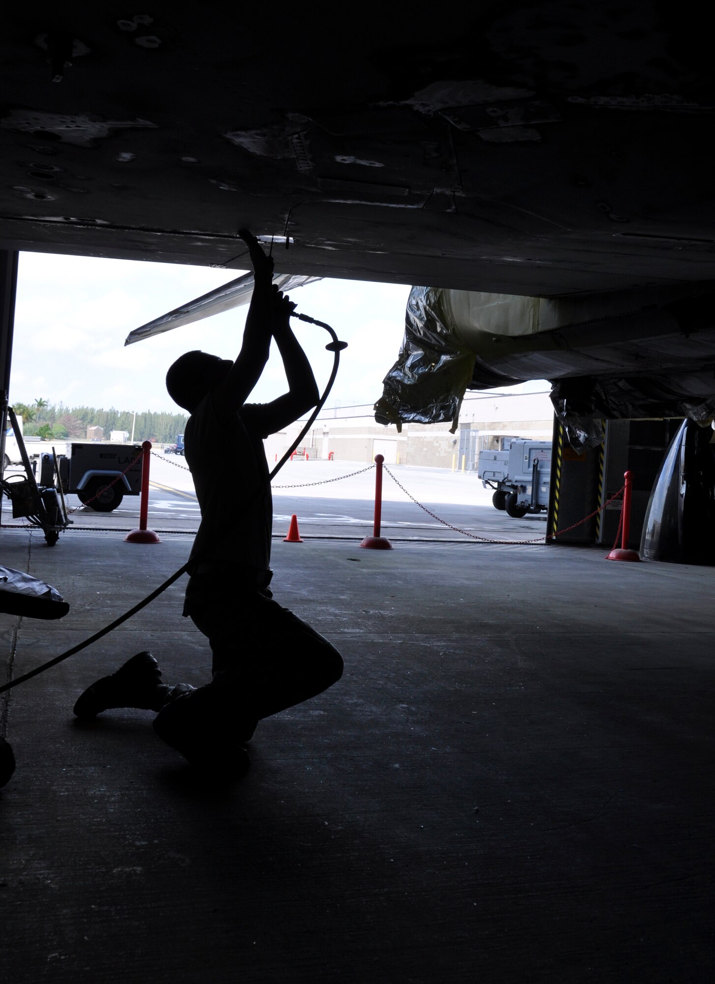 Airman 1st Class Christopher Pacheco, 482nd Maintenance Squadron structural maintenance, performs repairs on an F-4 Phantom II static display at Homestead Air Reserve Base, Fla., Feb. 25. The F-4, which is displayed on U.S. Route 1 in Homestead, Fla., will receive more than 2,000 hours of structural maintenance, repairs, and paint work at Homestead ARB. Homestead Air Force Base utilized the F-4 from 1981 to 1989. Once the repairs and painting are complete, the static display will be returned to its pedestal in Homestead. (U.S. Air Force photos/Ross Tweten)