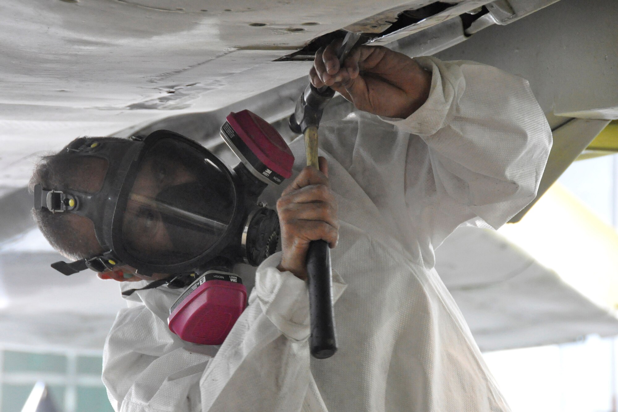 Master Sgt. Jose Quirindongo, 482nd Maintenance Squadron structural maintenance, performs repairs on an F-4 Phantom II static display at Homestead Air Reserve Base, Fla., Feb. 25. The F-4, which is displayed on U.S. Route 1 in Homestead, Fla., will receive more than 2,000 hours of structural maintenance, repairs, and paint work at Homestead ARB. Homestead Air Force Base utilized the F-4 from 1981 to 1989. Once the repairs and painting are complete, the static display will be returned to its pedestal in Homestead. (U.S. Air Force photos/Ross Tweten)