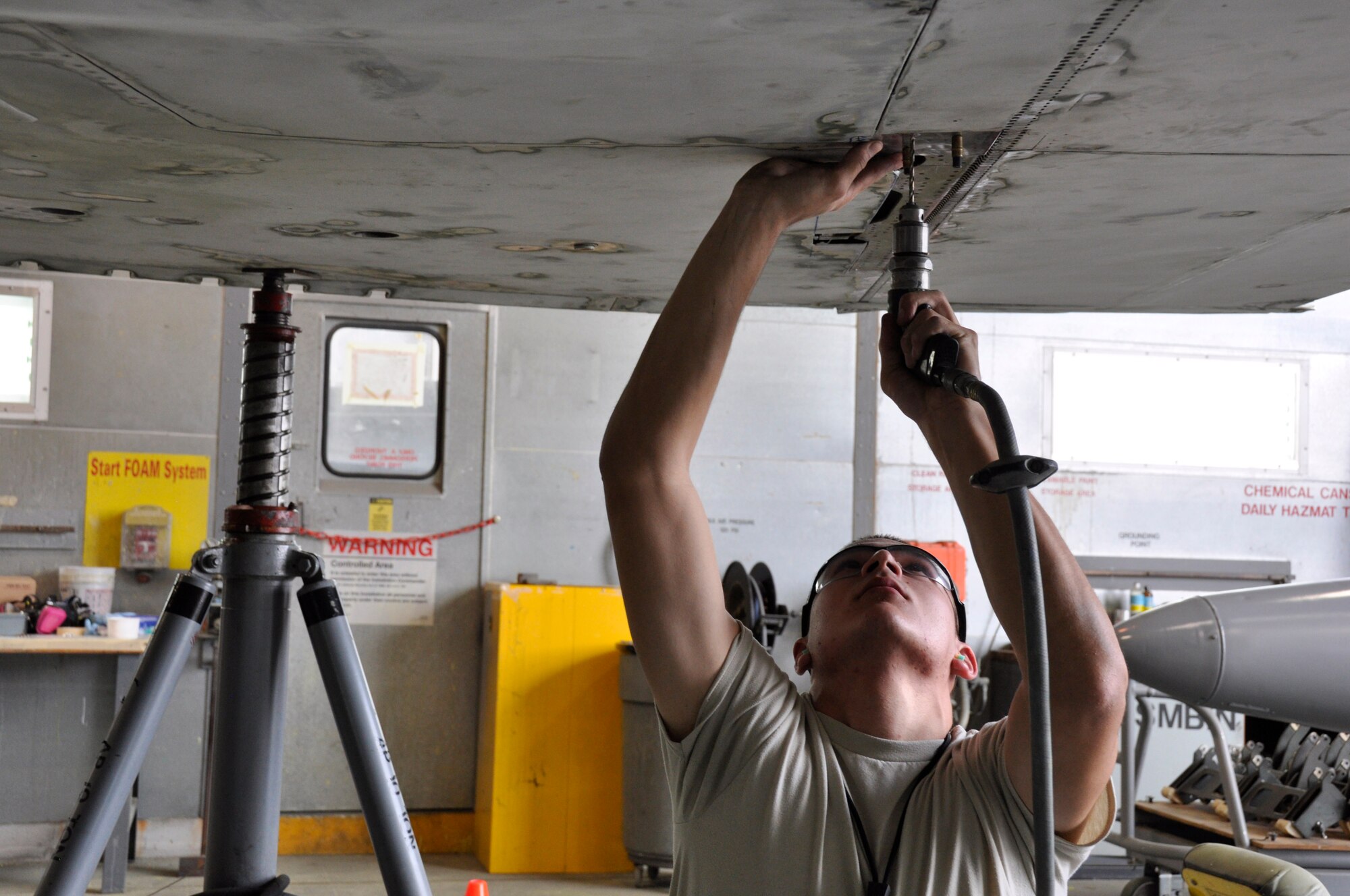 Airman 1st Class Christopher Pacheco, 482nd Maintenance Squadron structural maintenance, performs repairs on an F-4 Phantom II static display at Homestead Air Reserve Base, Fla., Feb. 25. The F-4, which is displayed on U.S. Route 1 in Homestead, Fla., will receive more than 2,000 hours of structural maintenance, repairs, and paint work at Homestead ARB. Homestead Air Force Base utilized the F-4 from 1981 to 1989. Once the repairs and painting are complete, the static display will be returned to its pedestal in Homestead. (U.S. Air Force photos/Ross Tweten)