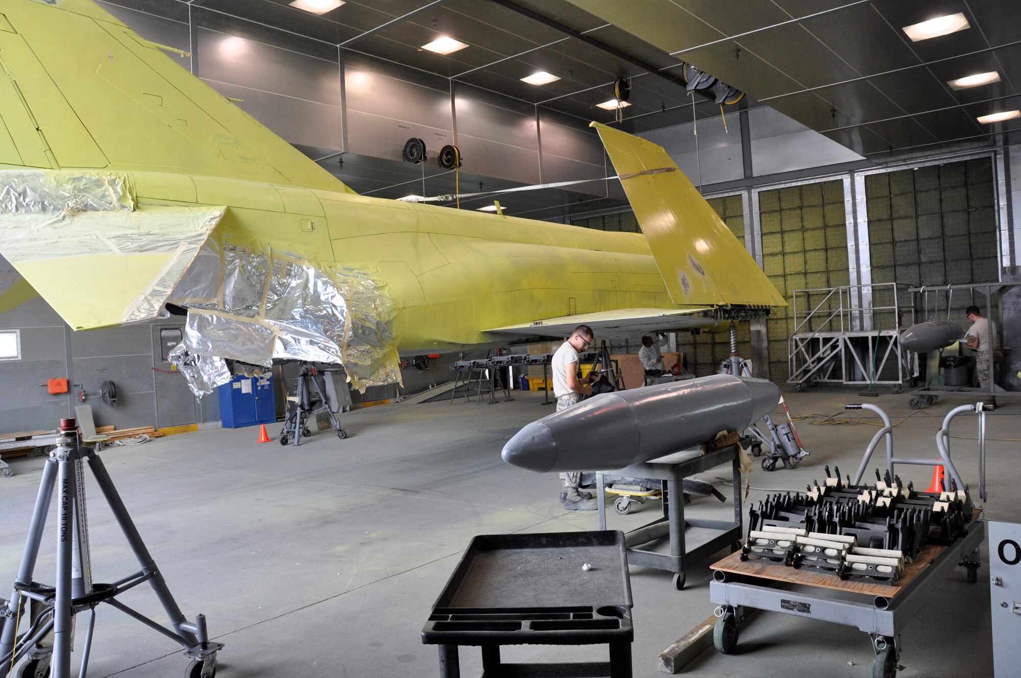 Airmen from the 482nd Maintenance Squadron at Homestead Air Reserve Base, Fla., performing repairs on an F-4 Phantom II static display Feb. 25. The F-4, which is displayed on U.S. Route 1 in Homestead, Fla., will receive more than 2,000 hours of structural maintenance, repairs, and paint work at Homestead ARB. Homestead Air Force Base utilized the F-4 from 1981 to 1989. Once the repairs and painting are complete, the static display will be returned to its pedestal in Homestead. (U.S. Air Force photos/Ross Tweten)