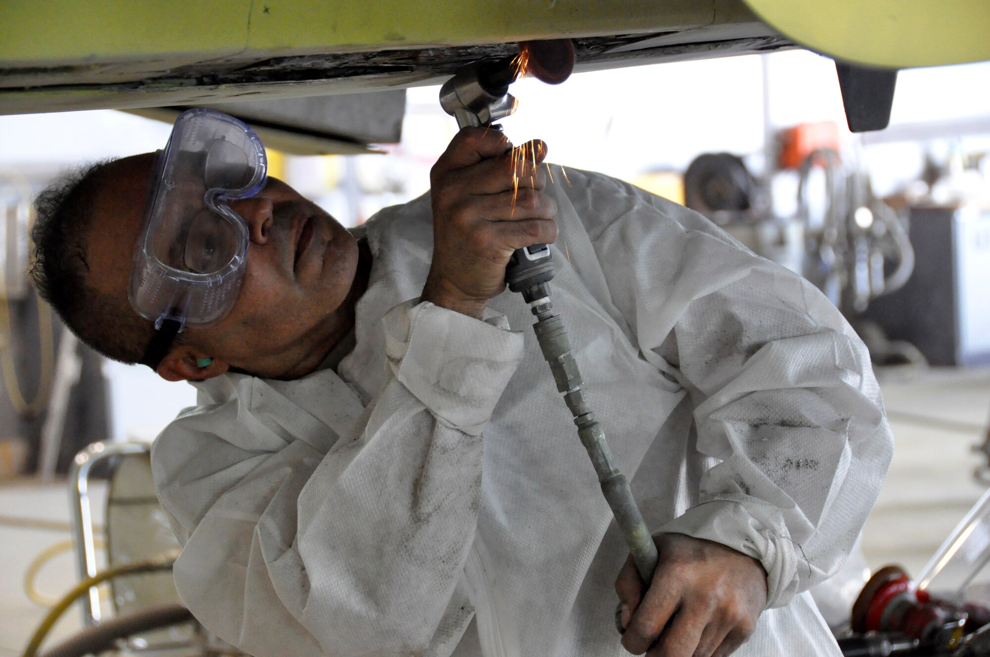 Master Sgt. Jose Quirindongo, 482nd Maintenance Squadron structural maintenance, performs repairs on an F-4 Phantom II static display at Homestead Air Reserve Base, Fla., Feb. 25. The F-4, which is displayed on U.S. Route 1 in Homestead, Fla., will receive more than 2,000 hours of structural maintenance, repairs, and paint work at Homestead ARB. Homestead Air Force Base utilized the F-4 from 1981 to 1989. Once the repairs and painting are complete, the static display will be returned to its pedestal in Homestead. (U.S. Air Force photos/Ross Tweten)
