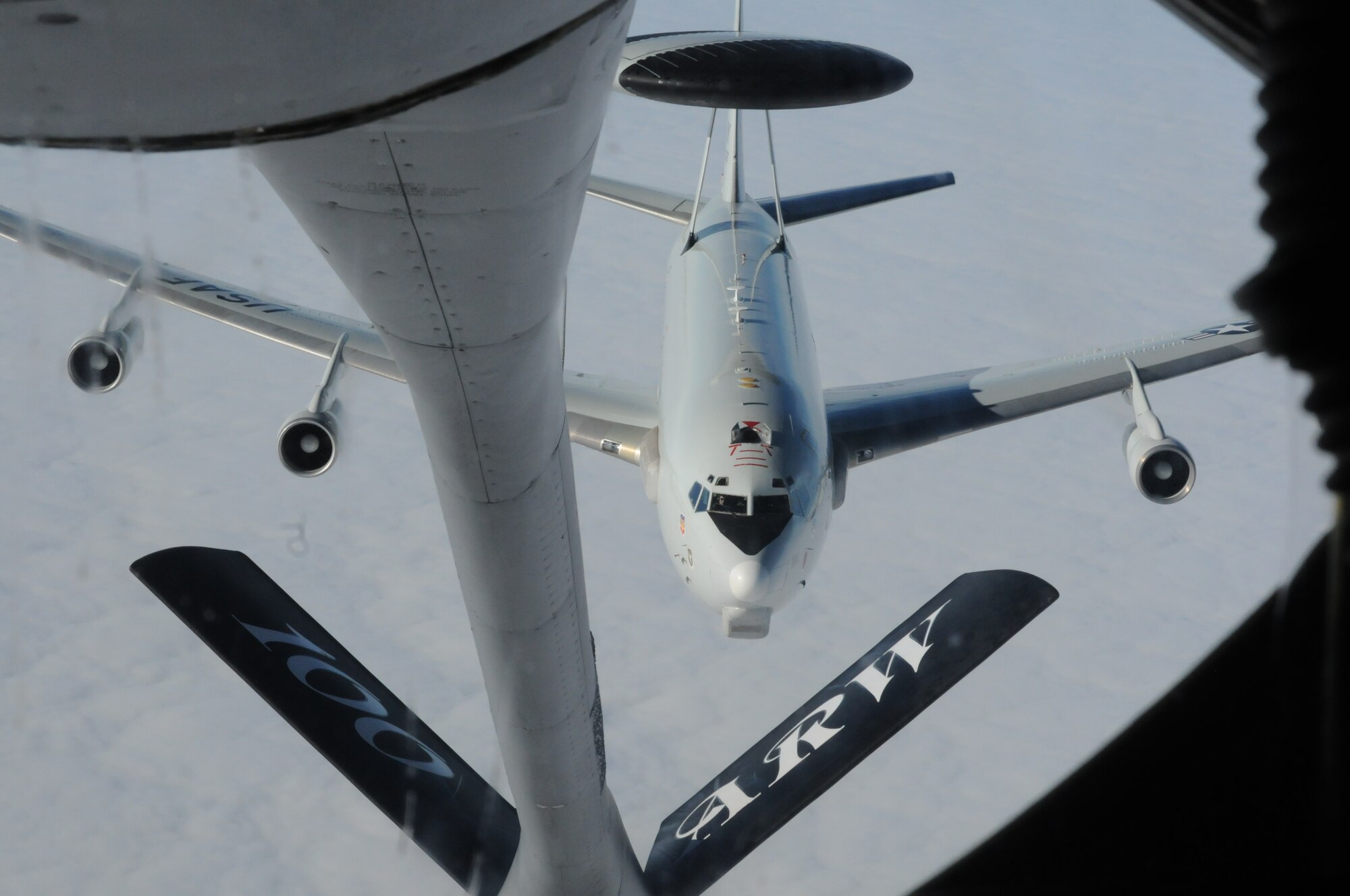 An E-3 Sentry from Tinker Air Force Base, Okla., breaks away after receiving fuel from a KC-135 Stratotanker from the 100th Air Refueling Wing at RAF Mildenhall, England, Feb. 22, 2013, as a part of a refueling mission over Scotland. The KC-135 provides aerial refueling to aircraft all over the world, including the 100th ARW’s area of operation of more than eight million square miles over Europe, Africa and the Mediterranean. (U.S. Air Force photo by 1st Lt. Christopher Mesnard/Released)