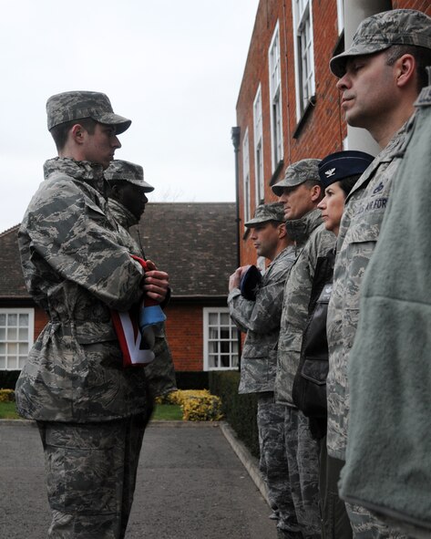 Airmen from the 100th Mission Support Group present the American and British flags to base leadership during a monthly retreat ceremony Feb. 22, 2013, at RAF Mildenhall, England. Retreat is a ceremony symbolizing the end of the duty day as well as paying respect to the flags. (U.S. Air Force photo by Airman 1st Class Kelsey Waters/Released)