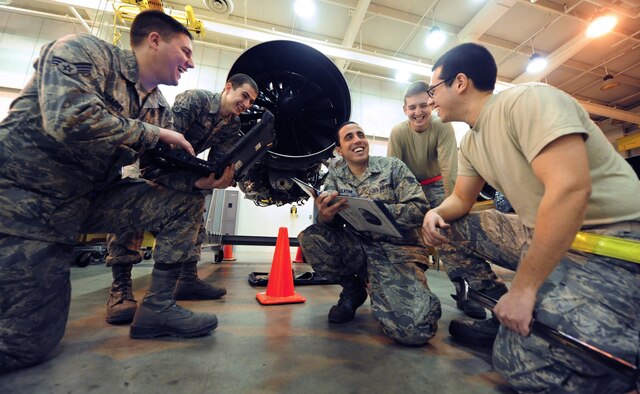 WHITEMAN AIR FORCE BASE, Mo. -- Aerospace propulsion mechanics from the 509th Maintenance Squadron share a laugh while reviewing technical data, Feb. 13. Technical data gives maintainers an in- depth, step-by-step description of how tasks need to be performed. (U.S. Air Force photo/Staff Sgt. Nick Wilson) (Released)