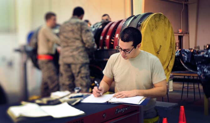 WHITEMAN AIR FORCE BASE, Mo. -- Senior Airman David Ides, 509th Maintenance Squadron aerospace propulsion journeyman, annotates maintenance accomplishments for a work package, Feb. 13. The work package documents the history of all work that has been performed on the engine being maintained. (U.S. Air Force photo/Staff Sgt. Nick Wilson) (Released)